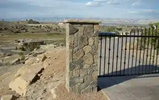 Stone gate pillars on long driveway to house